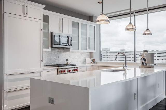 225 N New Jersey St Unit 52, Indianapolis, IN 46204 - kitchen featuring stainless steel microwave, paneled built in refrigerator, backsplash, and light countertops