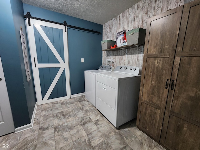 7511 Eddie Ln, Camby, IN 46113 - laundry room with washing machine and dryer, a barn door, wallpapered walls, and a textured ceiling