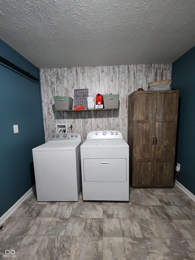 7511 Eddie Ln, Camby, IN 46113 - laundry area featuring washer and dryer, a textured ceiling, and a barn door