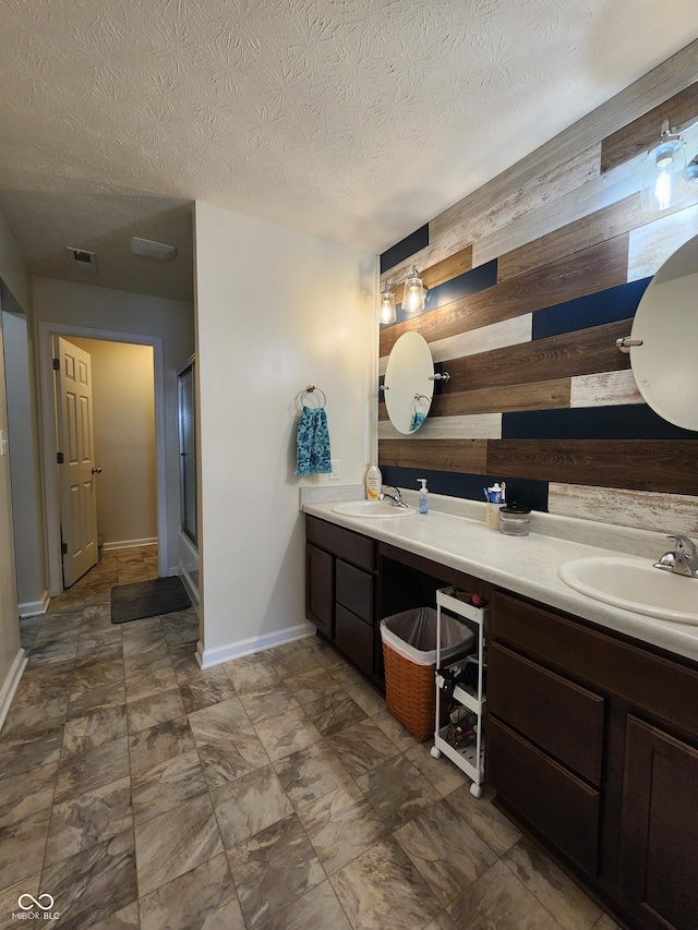 7511 Eddie Ln, Camby, IN 46113 - bathroom featuring wood walls, double vanity, a shower with door, and a textured ceiling