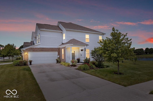 2499 Blue Ridge Dr, Greenwood, IN 46143 - view of front of house with a front yard, a garage, driveway, and brick siding