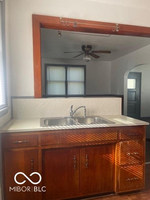 416 W 21st St, Anderson, IN 46016 - kitchen featuring a ceiling fan, arched walkways, and light countertops