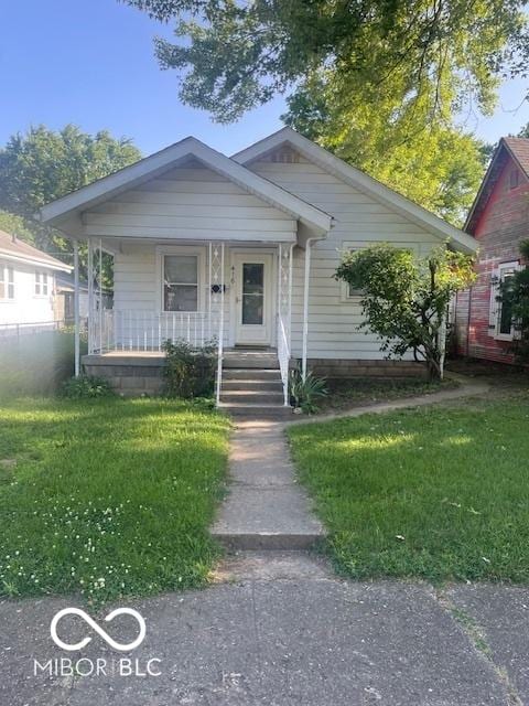 416 W 21st St, Anderson, IN 46016 - view of front facade featuring a porch and a front lawn
