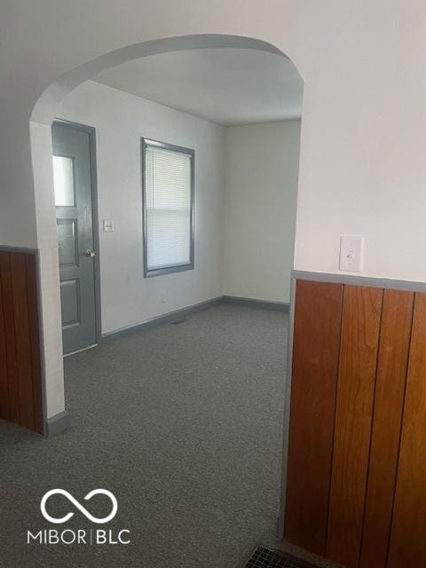 416 W 21st St, Anderson, IN 46016 - empty room with dark carpet and arched walkways