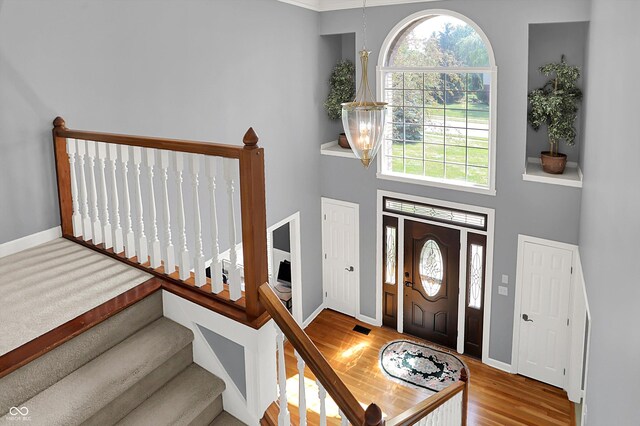 13779 Stone Dr, Carmel, IN 46032 - entryway featuring stairway, wood finished floors, and a towering ceiling