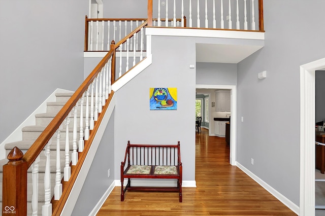 13779 Stone Dr, Carmel, IN 46032 - staircase featuring wood finished floors and a high ceiling