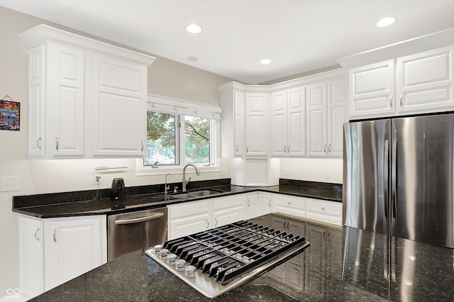 13779 Stone Dr, Carmel, IN 46032 - kitchen with appliances with stainless steel finishes, white cabinets, dark stone countertops, and recessed lighting