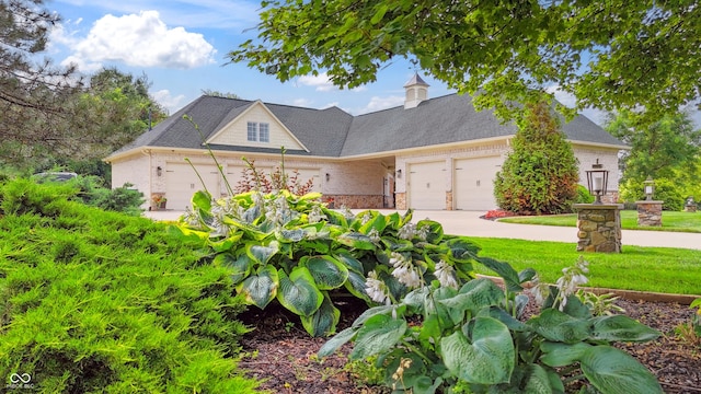 3399 Nottinghill Blvd, Plainfield, IN 46168 - view of front facade with an attached garage, brick siding, and driveway