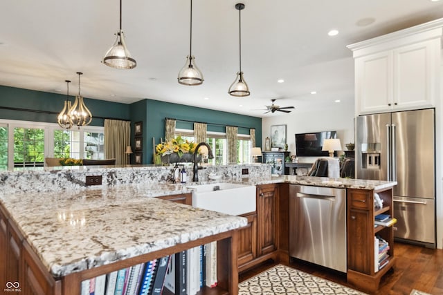 3399 Nottinghill Blvd, Plainfield, IN 46168 - kitchen with appliances with stainless steel finishes, dark wood finished floors, ceiling fan, recessed lighting, and light stone countertops