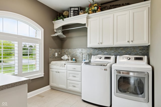 3399 Nottinghill Blvd, Plainfield, IN 46168 - laundry room with cabinet space, washer and clothes dryer, and light tile patterned floors