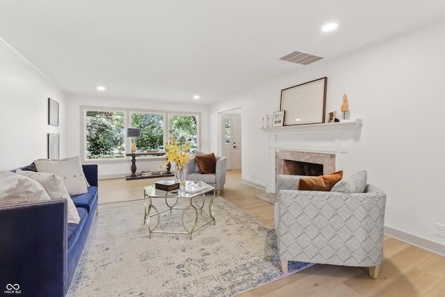 8246 Windcombe Blvd, Indianapolis, IN 46240 - living room featuring a fireplace with flush hearth, light wood-style floors, and recessed lighting