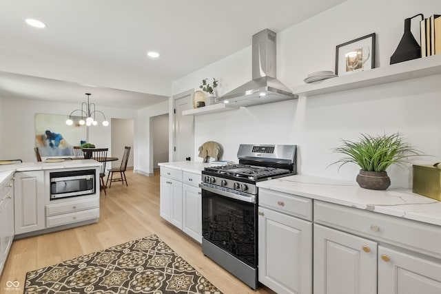8246 Windcombe Blvd, Indianapolis, IN 46240 - kitchen featuring stainless steel appliances, wall chimney range hood, light wood-style flooring, a chandelier, and recessed lighting