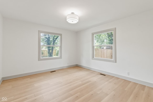 8246 Windcombe Blvd, Indianapolis, IN 46240 - empty room with plenty of natural light and light wood-style floors