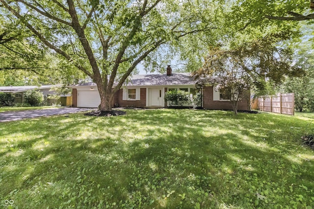 8246 Windcombe Blvd, Indianapolis, IN 46240 - view of front of property with brick siding, an attached garage, a chimney, and asphalt driveway