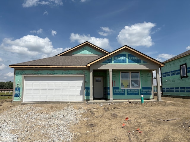 201 Holly Ln, Greenfield, IN 46140 - property in mid-construction with a shingled roof, an attached garage, a porch, and driveway