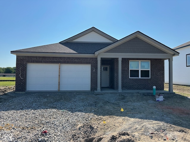 201 Holly Ln, Greenfield, IN 46140 - ranch-style home featuring brick siding, an attached garage, a shingled roof, and driveway