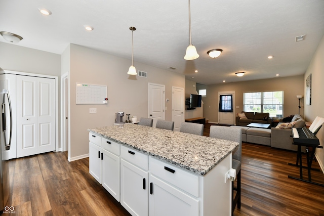 3443 Thomas Jefferson St, Westfield, IN 46074 - kitchen featuring dark wood-type flooring, a breakfast bar, white cabinets, hanging light fixtures, and a kitchen island
