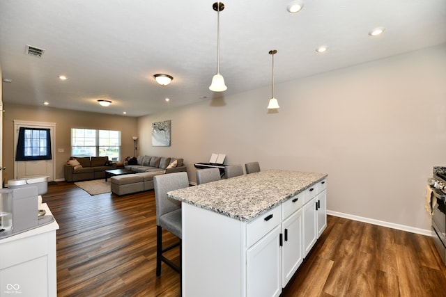 3443 Thomas Jefferson St, Westfield, IN 46074 - kitchen with a kitchen breakfast bar, white cabinetry, dark wood-style floors, decorative light fixtures, and recessed lighting