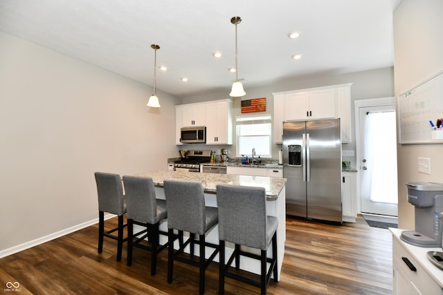3443 Thomas Jefferson St, Westfield, IN 46074 - kitchen with appliances with stainless steel finishes, a kitchen island, a kitchen breakfast bar, white cabinetry, and recessed lighting