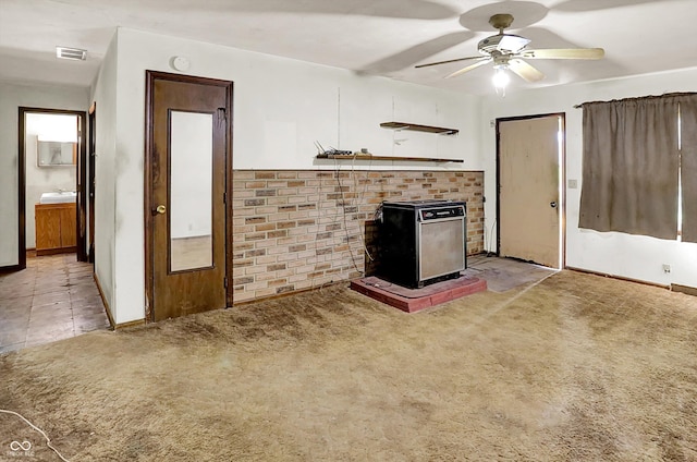 10159 Hodge Rd, Clayton, IN 46118 - unfurnished living room with carpet, ceiling fan, and a wood stove