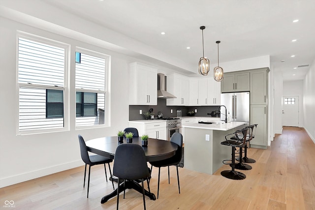 2015 Yandes St, Indianapolis, IN 46202 - kitchen featuring stainless steel appliances, plenty of natural light, a kitchen island with sink, light wood-style flooring, and recessed lighting