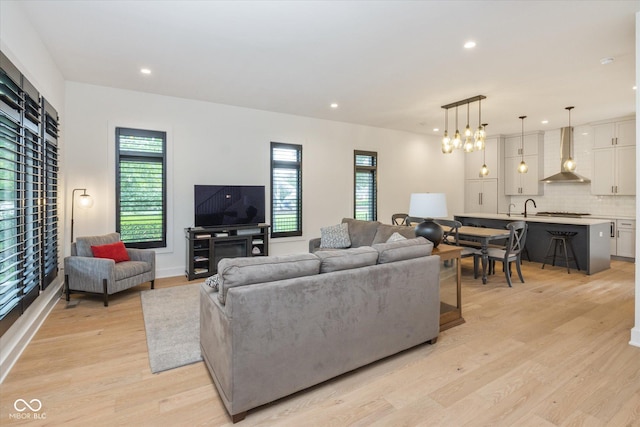 1905 N Alabama St, Indianapolis, IN 46202 - living area with healthy amount of natural light, light wood finished floors, recessed lighting, and a chandelier