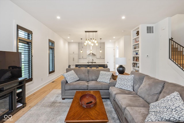 1905 N Alabama St, Indianapolis, IN 46202 - living room with light wood-style flooring, stairs, and recessed lighting