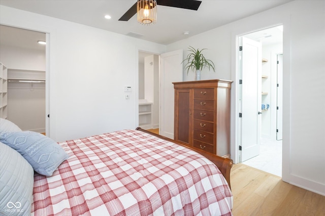 1905 N Alabama St, Indianapolis, IN 46202 - bedroom with light wood-type flooring, recessed lighting, a walk in closet, ceiling fan, and a closet