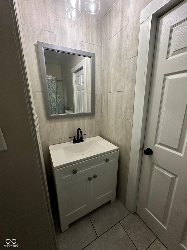 1810 N Parker Ave, Indianapolis, IN 46218 - bathroom with vanity, tile patterned floors, and tile walls