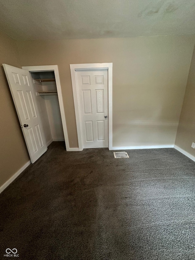 1810 N Parker Ave, Indianapolis, IN 46218 - unfurnished bedroom featuring dark colored carpet and a closet