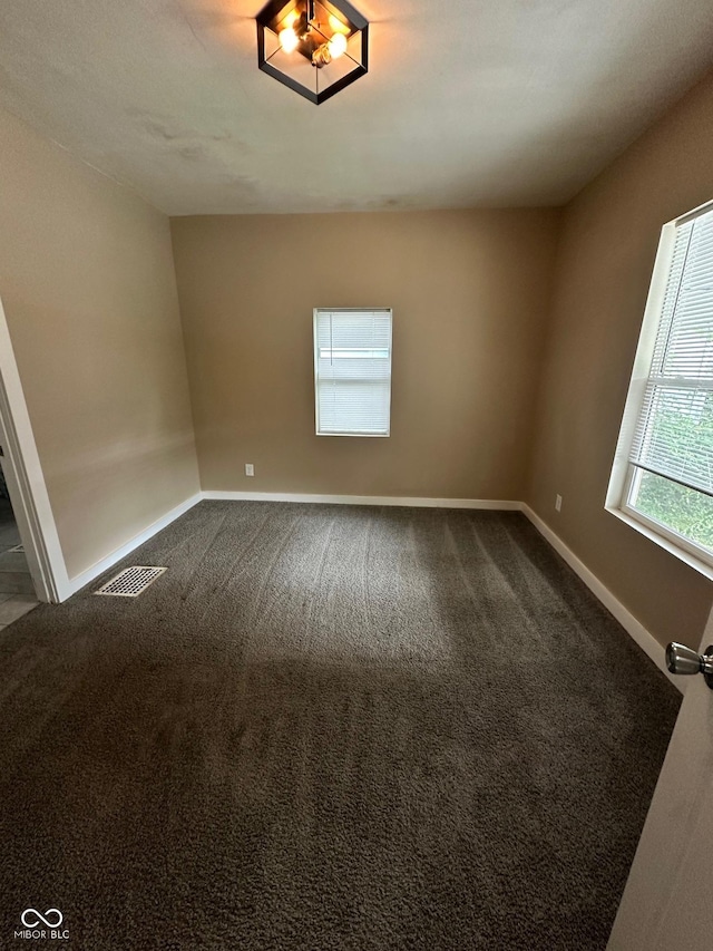 1810 N Parker Ave, Indianapolis, IN 46218 - unfurnished room with baseboards and dark colored carpet