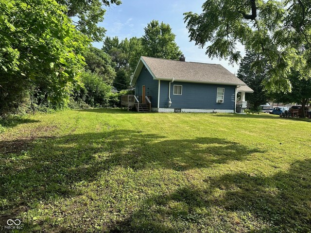 1810 N Parker Ave, Indianapolis, IN 46218 - rear view of property featuring a deck, a yard, and a chimney