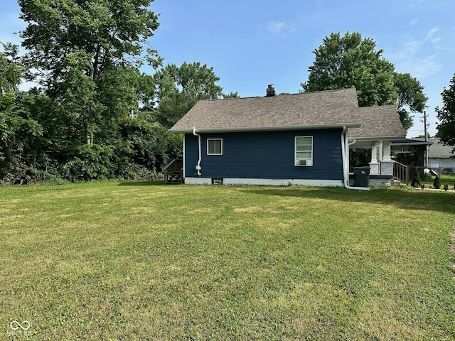 1810 N Parker Ave, Indianapolis, IN 46218 - view of side of property with a lawn, a chimney, cooling unit, and a shingled roof