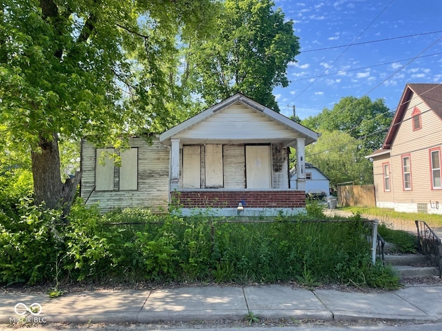 2625 E 12th St, Indianapolis, IN 46201 - bungalow-style home featuring a porch and brick siding