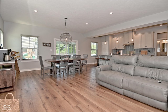 2734 Chalbury Dr, Plainfield, IN 46168 - living room featuring light wood-style flooring, recessed lighting, and a chandelier