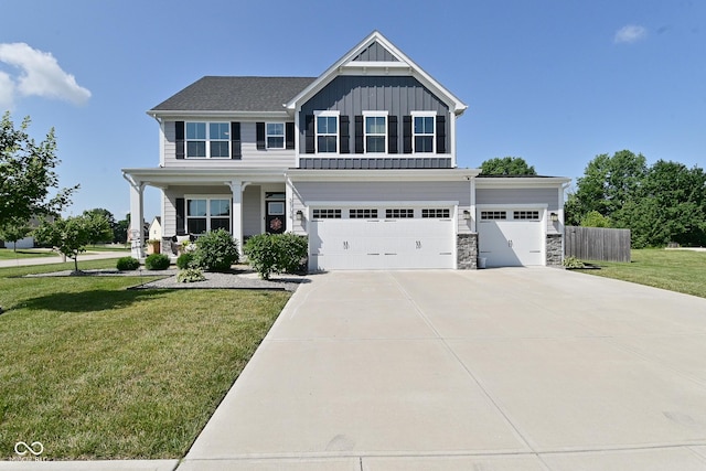 2734 Chalbury Dr, Plainfield, IN 46168 - view of front of home with board and batten siding, concrete driveway, stone siding, an attached garage, and a porch