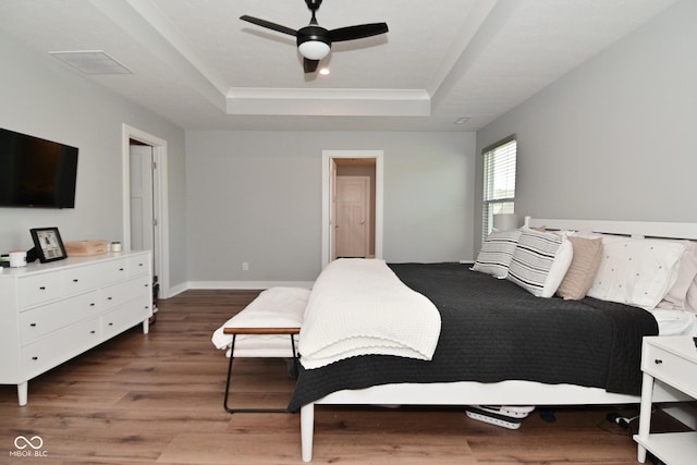 2734 Chalbury Dr, Plainfield, IN 46168 - bedroom featuring a tray ceiling, wood finished floors, and ceiling fan