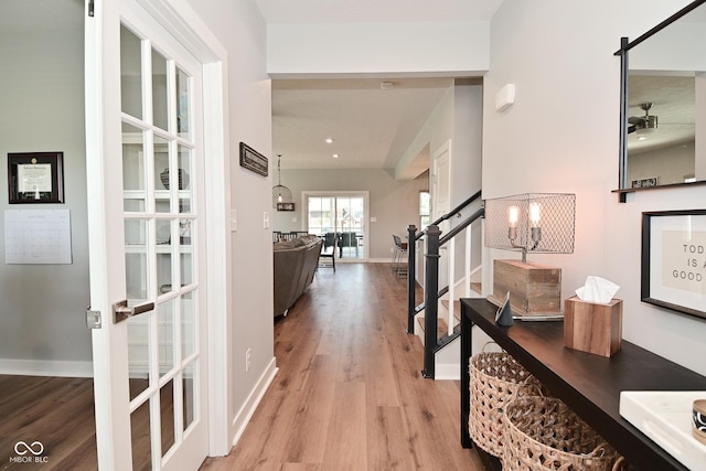 2734 Chalbury Dr, Plainfield, IN 46168 - hall with light wood-type flooring, stairway, and a chandelier
