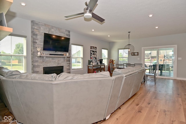 2734 Chalbury Dr, Plainfield, IN 46168 - living area with light wood-type flooring, ceiling fan, a fireplace, recessed lighting, and a chandelier