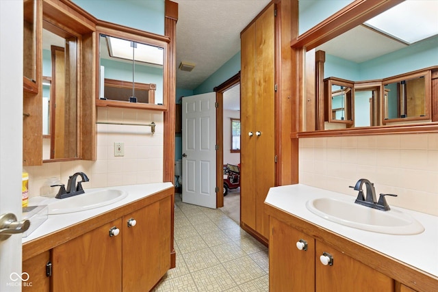 7516 S County Road 300 W, Clayton, IN 46118 - bathroom featuring tasteful backsplash, vanity, tile patterned floors, and tile walls