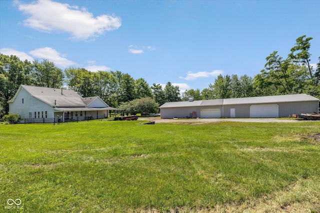 7516 S County Road 300 W, Clayton, IN 46118 - view of green lawn featuring a garage, an outbuilding, and view of scattered trees