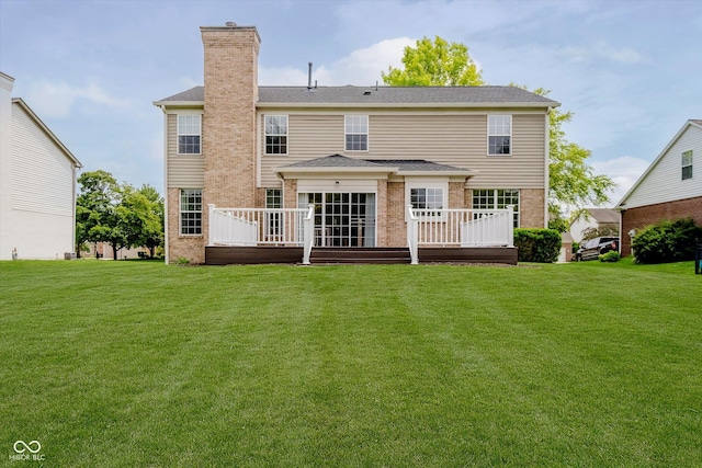 12490 Windbush Way, Carmel, IN 46033 - back of property featuring a chimney, brick siding, a wooden deck, and a lawn