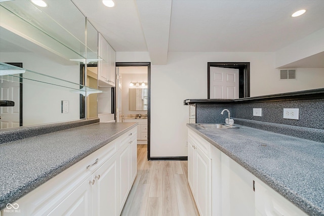 12490 Windbush Way, Carmel, IN 46033 - kitchen featuring light wood finished floors, white cabinetry, recessed lighting, and backsplash