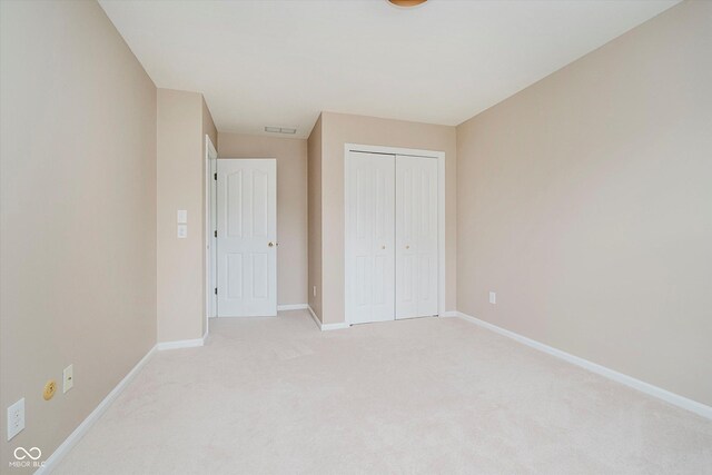 12490 Windbush Way, Carmel, IN 46033 - unfurnished bedroom featuring light colored carpet and a closet