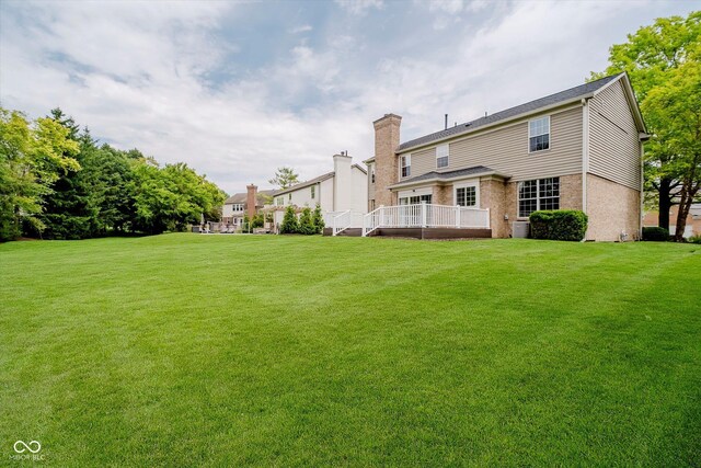 12490 Windbush Way, Carmel, IN 46033 - rear view of property with a lawn, a chimney, and brick siding