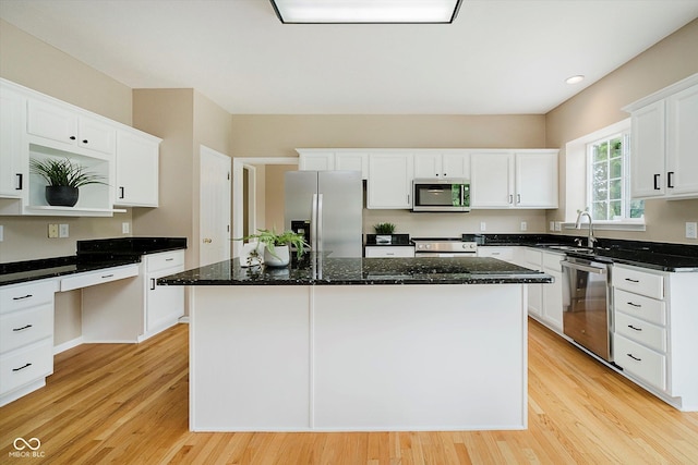 12490 Windbush Way, Carmel, IN 46033 - kitchen with stainless steel appliances, light wood-style flooring, white cabinetry, a center island, and recessed lighting
