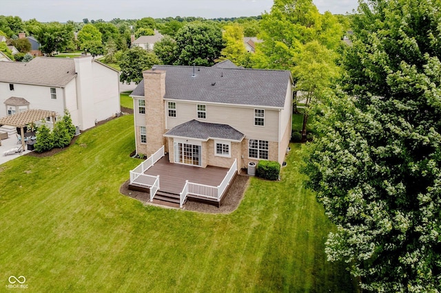 12490 Windbush Way, Carmel, IN 46033 - back of house with a wooden deck, a yard, roof with shingles, and a chimney