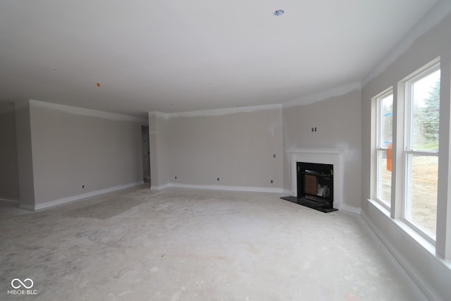 4999 Hummingbird Dr, Brownsburg, IN 46112 - unfurnished living room featuring unfinished concrete floors and a fireplace with raised hearth