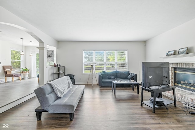2463 Kettering Way, Indianapolis, IN 46214 - living room with arched walkways, wood finished floors, and a brick fireplace