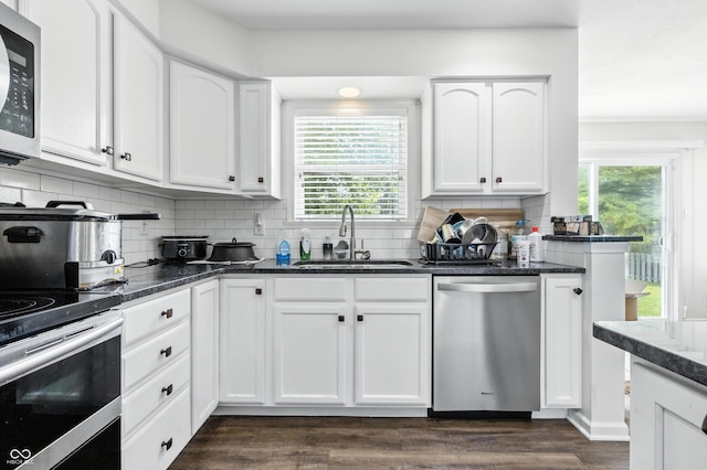 2463 Kettering Way, Indianapolis, IN 46214 - kitchen with stainless steel appliances, plenty of natural light, tasteful backsplash, and white cabinets